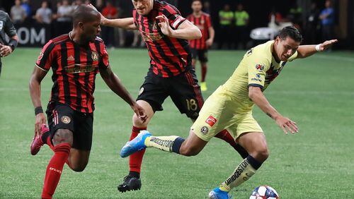 Atlanta United players Darlington Nagbe (left) and Jeff Larentowicz defend against Club America defender Jorge Sanchez in the Campeones Cup on Wednesday, August 14, 2019, in Atlanta.   Curtis Compton/ccompton@ajc.com
