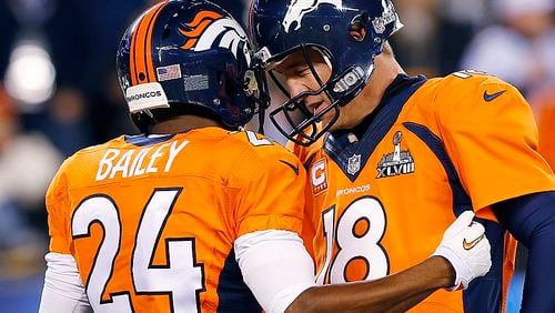Denver Broncos' Champ Bailey, left, speaks with quarterback Peyton Manning before the NFL Super Bowl XLVIII football game against the Seattle Seahawks on Sunday, Feb. 2, 2014, in East Rutherford, N.J. (AP Photo/Paul Sancya)