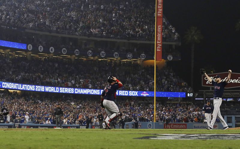 Boston Red Sox catcher Christian Vazquez celebrates with pitcher Chris Sale (right) after Game 5 of baseball's World Series against the Los Angeles Dodgers on Sunday, Oct. 28, 2018, in Los Angeles. The Red Sox won 5-1 to win the series 4 game to 1. (AP Photo/David J. Phillip)