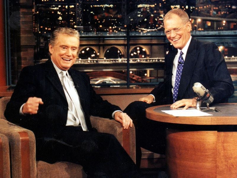 Regis Philbin, left, shares a laugh with comedian David Letterman Feb. 2000. Philbin was Letterman’s first guest since returning from quintuple bypass surgery on Jan. 14, 2000. (AP Photo/CBS, Barbara Nitke)