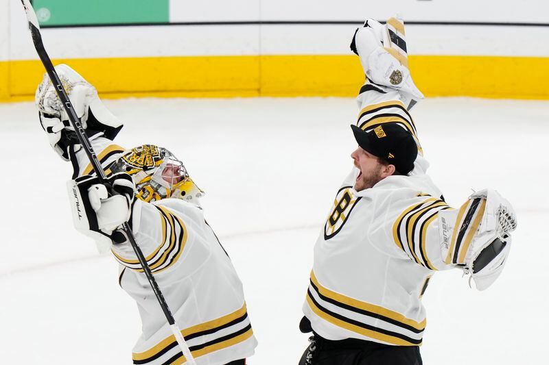 Boston Bruins goaltender Jeremy Swayman, left, and goaltender Linus Ullmark celebrate after defeating the Toronto Maple Leafs in Game 3 of an NHL hockey Stanley Cup first-round playoff series in Toronto on Wednesday, April 24, 2024. (Frank Gunn/The Canadian Press via AP)