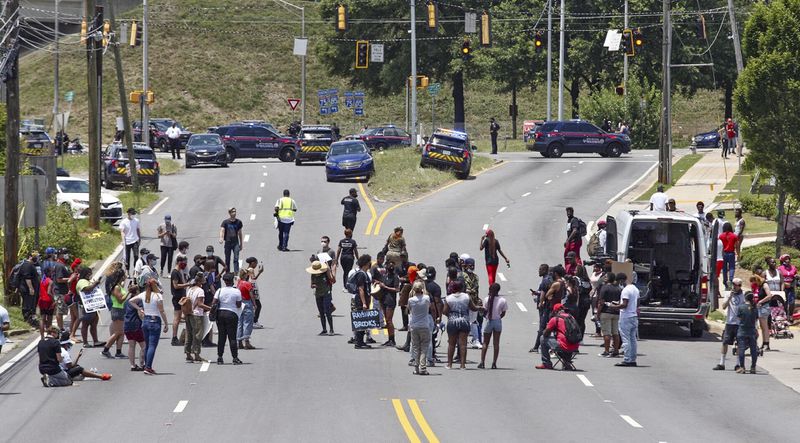 Protestors block University Avenue and the on-ramp to I-75  near the Wendy's where Rayshard Brooks was shot and killed by Atlanta police. 
 Steve Schaefer for the Atlanta Journal Constitution