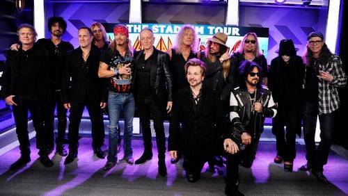 Musicians Rick Allen, from left, Tommy Lee, Vivian Campbell, Joe Elliott, Bret Michaels, Phil Collen, Rick Savage, Rikki Rokkett (kneeling), C.C. DeVille, Nikki Sixx (kneeling), Vince Neil, Mick Mars and Bobby Dall pose together following a news conference to announce The Stadium Tour 2020 featuring rock bands Motley Crue, Def Leppard and Poison, at the SiriusXM offices, Wednesday, Dec. 4, 2019, in Los Angeles. (Photo by Chris Pizzello/Invision/AP)