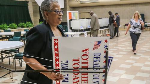 Poll manager Rosalind Smith gets ready to post signs as voters hit the voting machines at Mount Carmel Christian Church in Stone Mountain on Tuesday, May 24, 2016. JOHN SPINK / JSPINK@AJC.COM