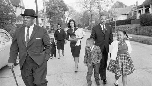In 1964, the Rev. Martin Luther King Jr. takes a Sunday family walk in Atlanta with his father the Rev. Martin Luther King Sr., son Dexter, sister Christine King Farris, wife Coretta Scott King holding daughter Bernice, son Martin Luther King III and daughter Yolanda. Copyright by Max Scheler Estate, Hamburg Germany.