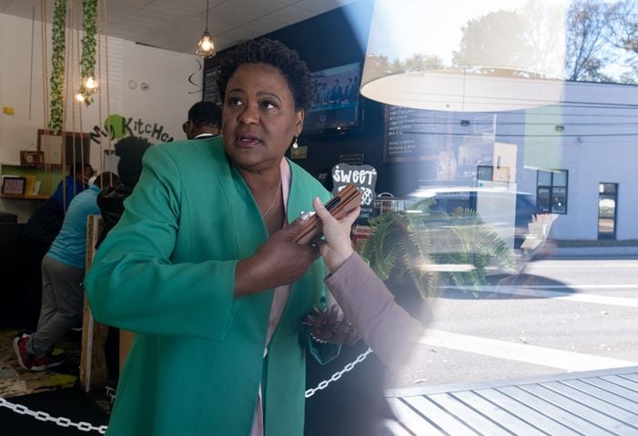 211120-Atlanta-Atlanta Mayoral candidate Felicia Moore takes a phone call while also talking to a reporter from the Washington Post while at a campaign stop at My Coffee Shop in East Lake on Saturday, Nov. 20, 2021. Ben Gray for the Atlanta Journal-Constitution