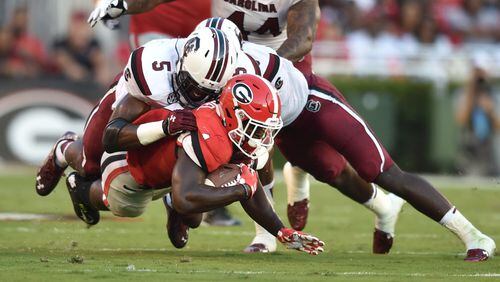 September 19, 2015 Athens, GA: Georgia Bulldogs running back Sony Michel is brought down by South Carolina Gamecocks defensive end Darius English during the first half in Athens Saturday September 19, 2015. BRANT SANDERLIN/BSANDERLIN@AJC.COM