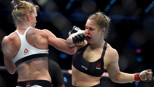 Holly Holm, left punches Ronda Rousey during thier UFC 193 Bantamweight title fight in Melbourne, Australia, Sunday, Nov. 15, 2015. (AP Andy Brownbill)