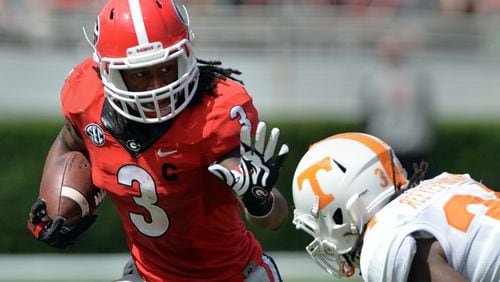 Georgia Bulldogs running back Todd Gurley tries to elude the tackle of Tennessee Volunteers linebacker Jalen Reeves-Maybin during the second quarter at Sanford Stadium Saturday September 27, 2014. BRANT SANDERLIN / BSANDERLIN@AJC.COM