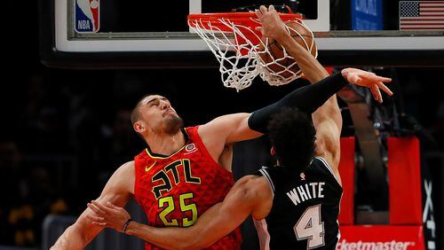 Derrick White of the San Antonio Spurs dunks against Alex Len of the Hawks at State Farm Arena on March 06, 2019 in Atlanta. (Photo by Kevin C.  Cox/Getty Images)