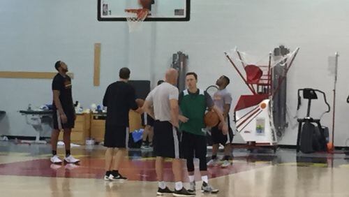Josh Magette (right) talks with assistant coach Neven Spahija after Hawks practice Monday. Photo by Chris Vivlamore