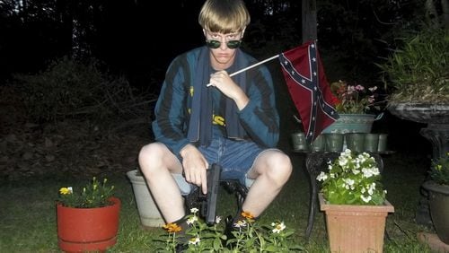 This undated photo that appeared on Lastrhodesian.com, a website investigated by the FBI in connection with Dylann Roof, shows him posing for a photo holding a Confederate flag. Roof, who would later admit he wanted to start a race war, fatally shot eight black worshippers and their pastor at the Emanuel African Methodist Episcopal Church in Charleston, South Carolina. The following week, Obama delivered the eulogy for the slain Rev. Clementa Pinckney, speaking about the symbolism of the Confederate flag and how racial bias infects everyday life. (Lastrhodesian.com via AP, File)