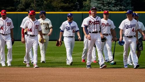 National League players take the field during batting practice for the MLB All-Star baseball game, Monday, July 12, 2021, in Denver. (AP Photo/Gabriel Christus)