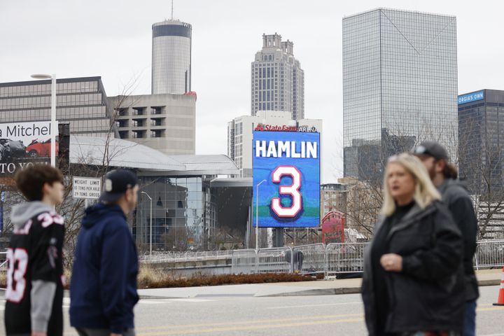 NFL teams continue to show support for Bills safety Damar Hamlin. Fans pass by a sign outside State Farm Arena on Sunday. Hamlin is recovering from a cardiac arrest suffered last Monday in Cincinnati. (Miguel Martinez / miguel.martinezjimenez@ajc.com)