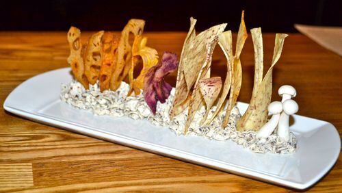 The black truffle cremini mushroom dip, an indulgently French onion-y cream cheese mixture, could almost serve as a centerpiece. Curled-edge strips of malanga root, lotus root and boniato in pale hues stand tall in a piped-ruffle cloud of the dip.