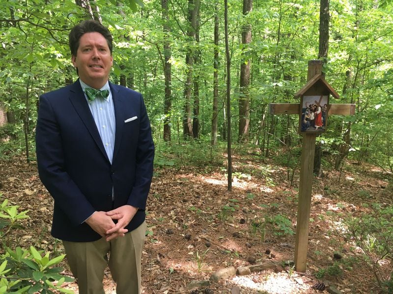 Kyle Pietrantonio, head of the Holy Spirit Preparatory School, stands for a picture amid land that would be cleared of some of its trees should the school be approved to expand. The proposal is meeting backlash and threats of a lawsuit from some in the neighborhood. (Ben Brasch/AJC)