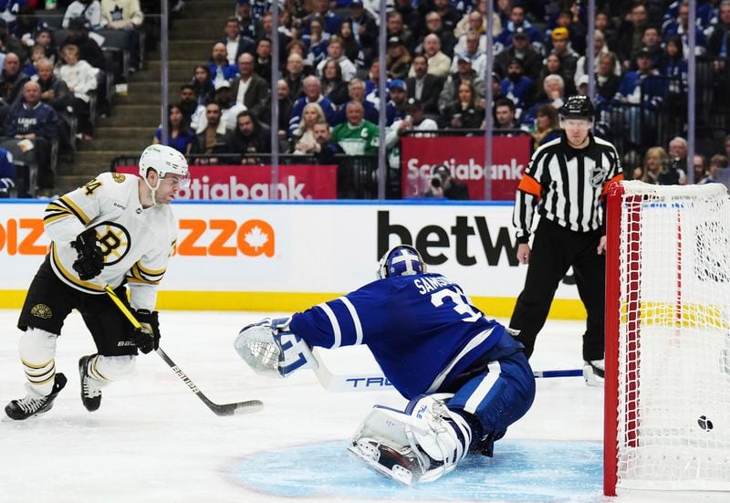 Boston Bruins' Jake DeBrusk (74) scores on Toronto Maple Leafs goaltender Ilya Samsonov (35) during the third period of action in Game 3 of an NHL hockey Stanley Cup first-round playoff series in Toronto on Wednesday, April 24, 2024. (Nathan Denette/The Canadian Press via AP)