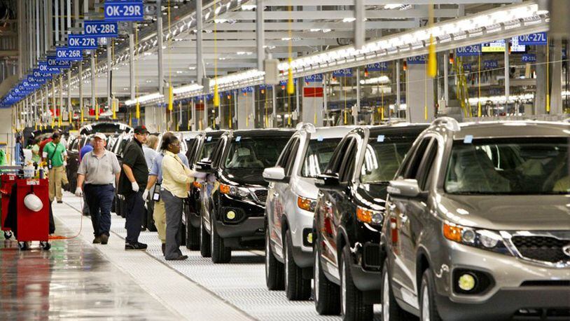 Nearly completed cars come down the assembly line at the Kia plant near West Point.