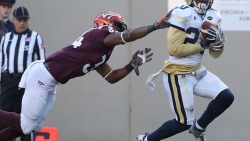 Georgia Tech safety Lawrence Austin (20) intercepts a pass in the endzone in front of Virginia Tech receiver Travon McMillian (34) during the first half of an NCAA football game in Blacksburg, Va., Saturday, Nov. 12 2016. (Matt Gentry/The Roanoke Times via AP)
