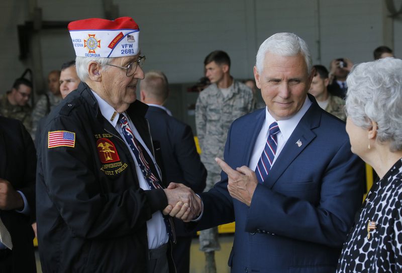 Vice President Mike Pence spent a moment talking with WWII Navy veteran Alan Hall, from Canton, and his wife, Buena, at Dobbins Air Reserve Base after speaking there Friday.
