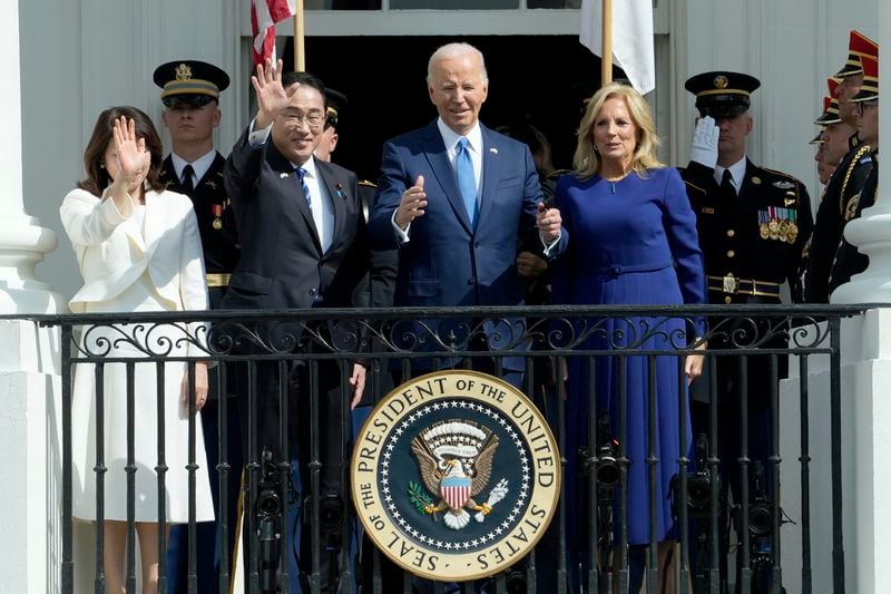 President Joe Biden, center right, and first lady Jill Biden, right, wave with Japanese Prime Minister Fumio Kishida, center left, and his wife Yuko Kishida, left, during a State Arrival Ceremony on the South Lawn of the White House, Wednesday, April 10, 2024, in Washington. (AP Photo/Susan Walsh)