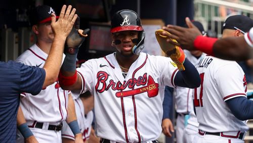 Braves’ Ronald Acuna Jr. celebrates with teammates in the dugout after scoring a run off of a single by Matt Olson during the fourth inning against the Philadelphia Phillies at Truist Park, Wednesday, Sept. 20, 2023, in Atlanta. The Phillies won 6-5 in 10 innings. (Jason Getz / Jason.Getz@ajc.com)