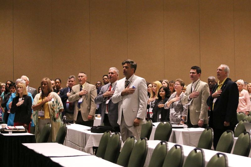 Georgia tax officials say the pledge of allegiance during the Georgia Association of Tax Officials Conference on May 6, 2019, at the Classic Center in Athens. A closely guarded provision of Georgia law allows county tax commissioners in Georgia to earn thousands of dollars in fees for collecting city taxes, on top of their county salaries. CHRISTINA R. MATACOTTA / CMATACOTTA@AJC.COM