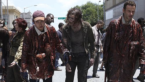 Steve Yeun (left) as Glenn and Andrew Lincoln (right) as Rick Grimes pretend to be zombies in the second episode of "The Walking Dead" on AMC on Mitchell Street. Shot in 2010.