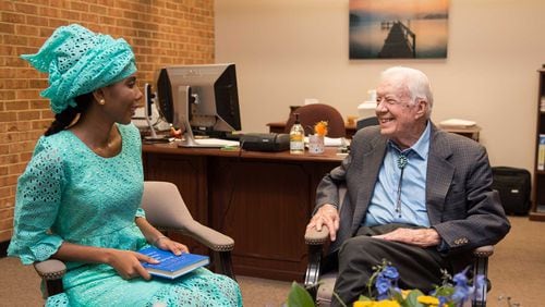 Jaha Dukureh, a 2018 Nobel Peace Prize nominee, talks with former President Jimmy Carter after her speech on Oct. 3, 2018 at Georgia Southwestern State University. Jaha was born in Gambia and has been an activist for women's rights, raising awareness about issues such as arranged marriages for teenage girls and female genital mutilation. Both are alumnus of the university. PHOTO CREDIT: DAVID PARKS PHOTOGRAPHY.