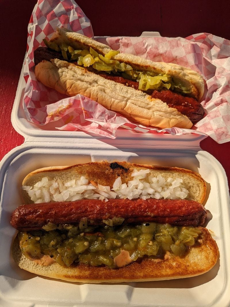 NFA Burger offers the Southsider (top), a one-third-pound Vienna beef Polish sausage, and the Jersey dog, a quarter-pound Angus beef hot dog with raw onions and green chiles. Paula Pontes for The Atlanta Journal-Constitution