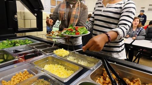 The debate these days is whether school lunches should be primarily healthy, as with this salad bar, or offer tasty dishes that students will eat. (Curtis Compton / AJC file)