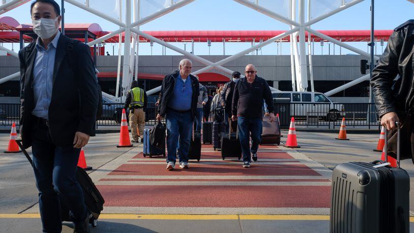 Travelers are seen at Hartsfield-Jackson airport in Atlanta on Friday, April 8, 2022.   (Arvin Temkar / arvin.temkar@ajc.com)