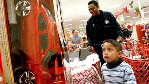 For free, certain Cobb children will go Christmas shopping with Cobb Police officers - thanks to the Cops & Kids Fundraiser Golf Tournament on Sept. 16. Also, funds will be used to pay all of the balances for the reduced lunch program in the Cobb County School District. AJC file photo