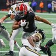 Atlanta Falcons running back Bijan Robinson (7) works through traffic and scores a touchdown during the first half of a NFL football game between the Atlanta Falcons and the New Orleans Saints in Atlanta on Sunday, Nov. 26, 2023.   (Bob Andres for the Atlanta Journal Constitution)