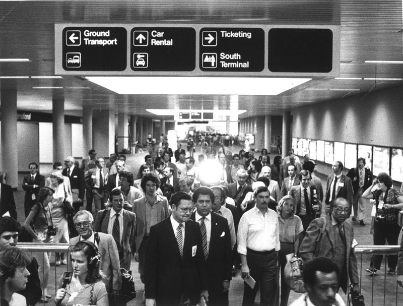Airport Comm. George Berry and mayor Maynard Jackson lead a gaggle of media types on a tour of the new airport as part of the dedication ceremonies hype Sept 18, 1980.