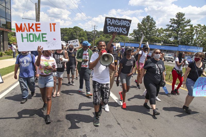  Protesters gather on University Avenue in Atlanta on Saturday  near the Wendy's where Rayshard Brooks, a 27-year-old black man,  was shot and killed by Atlanta police Friday evening during a struggle.  