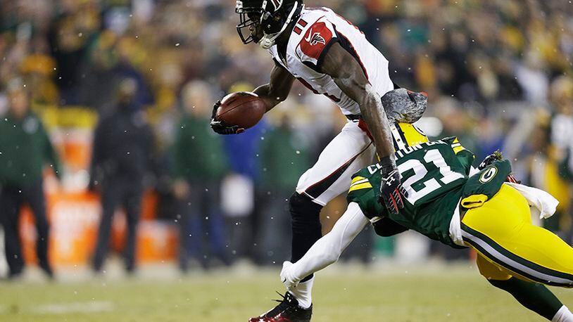 GREEN BAY, WI - DECEMBER 08: Julio Jones #11 of the Atlanta Falcons completes a reception against the defense of Ha Ha Clinton-Dix #21 of the Green Bay Packers in the first quarter at Lambeau Field on December 8, 2014 in Green Bay, Wisconsin. (Photo by Mike McGinnis/Getty Images) GREEN BAY, WI - DECEMBER 08: Julio Jones #11 of the Atlanta Falcons completes a reception against the defense of Ha Ha Clinton-Dix #21 of the Green Bay Packers in the first quarter at Lambeau Field on December 8, 2014 in Green Bay, Wisconsin. (Photo by Mike McGinnis/Getty Images)