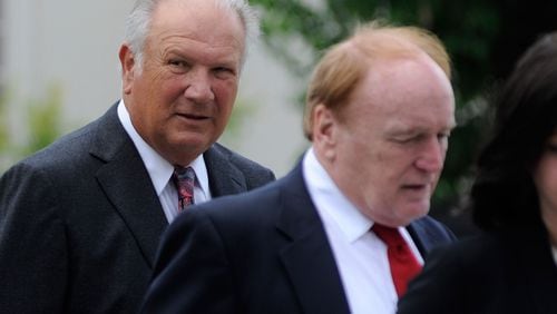 Former University of Georgia football coach Jim Donnan, left, heads into the Federal Courthouse on Wednesday, May 14, 2014, Athens, Ga. Prosecutors say the 69-year-old and another man ran a fraudulent investment scheme from September 2007 to December 2010 through GLC Limited, a West Virginia-based company dealing in wholesale and closeout merchandise. Prosecutors say the pair promised high rates of return but paid investors with other investor money. (AP Photo/Athens Banner-Herald, Richard Hamm) MAGS OUT; MANDATORY CREDIT Former Georgia coach Jim Donnan (with attorney Jerry Froelich) is awaiting jury's verdict. (Richard Hamm/Athens Banner Herald)