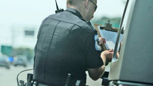 Cobb Police Officer Pete Jones tracked this individual going 78 mph, and is giving him his ticket to sign.