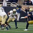 Georgia Tech's Dontae Smith (4) runs against Notre Dame's JD Bertrand (27) during the first half of an NCAA college football game, Saturday, Nov. 20, 2021, in South Bend, Ind. (AP Photo/Darron Cummings)