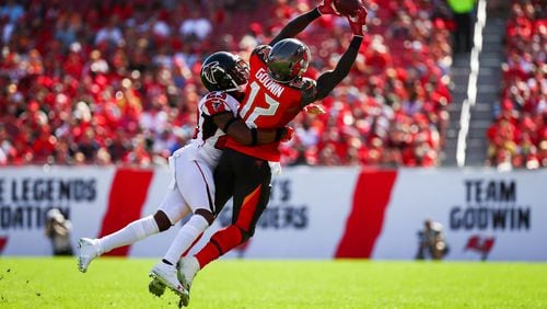 TAMPA, FL - DECEMBER 30: Wide receiver Chris Godwin #12 of the Tampa Bay Buccaneers is wrapped up by cornerback Robert Alford #23 of the Atlanta Falcons as he stretches for a pass from quarterback Jameis Winston #3 of the game at Raymond James Stadium on December 30, 2018 in Tampa, Florida. (Photo by Will Vragovic/Getty Images)