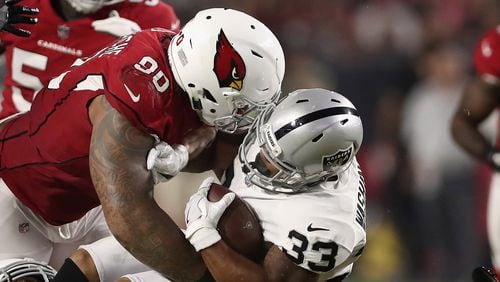 Defensive tackle Robert Nkemdiche of the Arizona Cardinals tackles running back DeAndre Washington of the Oakland Raiders for a loss during the second half of the NFL game at the University of Phoenix Stadium on August 12, 2017 in Glendale, Arizona. The Cardinals defeated the Raiders 20-10. (Photo by Christian Petersen/Getty Images)