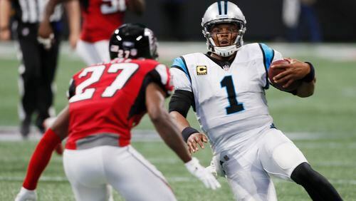 Panthers quarterback Cam Newton (1) starts to slide on a keeper as Atlanta Falcons cornerback Damontae Kazee (27) closes during the 2018 Panthers-Falcons matchup at Mercedes-Benz Stadium. (Bob Andres/AJC file photo)