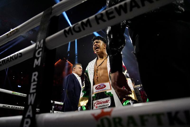 Jaime Munguia motions from the ring befor fighting Canelo Alvarez in a super middleweight title fight Saturday, May 4, 2024, in Las Vegas. (AP Photo/John Locher)