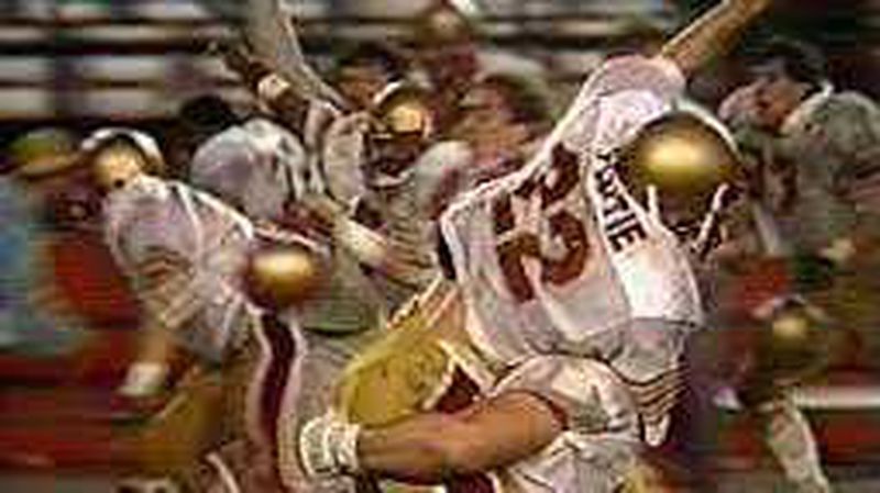 Doug Flutie celebrates after his "Hail Mary" pass is caught for the game-winning touchdown for Boston College against the Miami Hurricanes in 1984. Boston College saw an enrollment surge afterwards, which some call "the Flutie effect." PHOTO CREDIT: MIAMI HERALD.