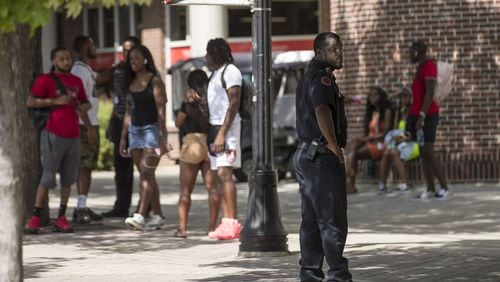 A Clark Atlanta University Police officer keeps an eye out as students socialize near the Clark Atlanta University student center on the main campus in Atlanta, Wednesday, August 21, 2019. The night before, a shooting took place on the promenade, an area near the library, injuring 2 Clark Atlanta University students and 2 Spelman College students. (Photo: Alyssa Pointer/alyssa.pointer@ajc.com)