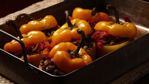 Serbian style stuffed red bell peppers are filled with ground beef, onion, peppers, garlic, pine nuts, rice and raisins.
(E. Jason Wambsgans/Chicago Tribune/TNS)