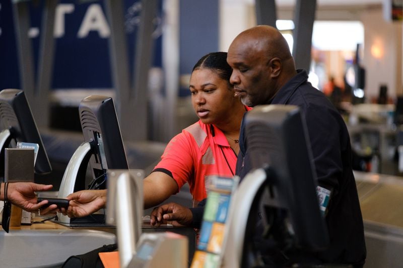 Delta employees are seen at Hartsfield-Jackson International Airport domestic terminal in Atlanta on Tuesday, April 19, 2022.  (Arvin Temkar / arvin.temkar@ajc.com)