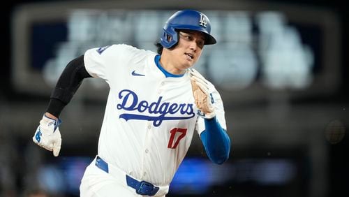 Los Angeles Dodgers designated hitter Shohei Ohtani rounds third on the way to scoring on a single by Will Smith during the seventh inning of a baseball game Friday, May 17, 2024, in Los Angeles. (AP Photo/Mark J. Terrill)