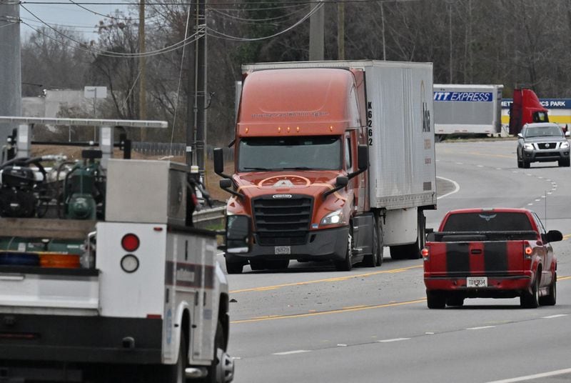 Photo shows truck traffics on Roosevelt Hwy, Friday, Feb. 10, 2023, in Fairburn. For years, former City of South Fulton Councilwoman Naeema Gilyard and other neighbors have been concerned about breathing smoke from the landfill, not to mention emissions from the steady stream of diesel big rigs that coming and going from warehouses that line South Fulton Parkway. Even with modern engines and cleaner fuel, exhaust from diesel trucks is known to contain a dangerous cocktail of air pollutants. (Hyosub Shin / Hyosub.Shin@ajc.com)